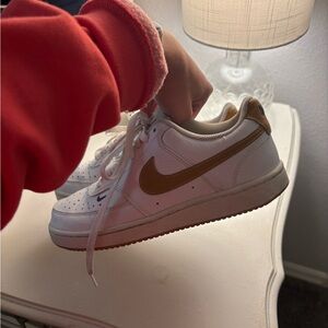Nike White Sneakers with Gold Swoosh